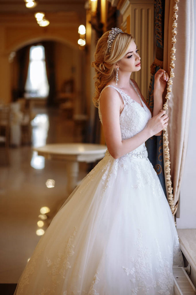 beautiful young woman bride in luxury wedding dress in interior - 写真・画像