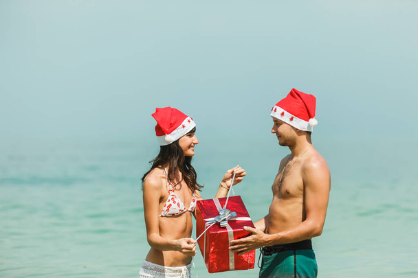 couple standing with gift box in water - 写真・画像
