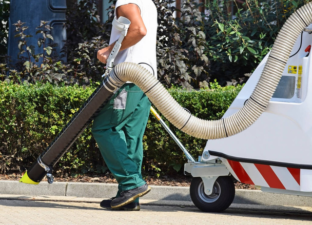 El limpiador de calles trabaja con un limpiador de vacíos
 - Foto, Imagen