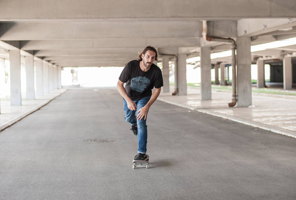 Professional skateboarder in underground passage - Foto, Imagem