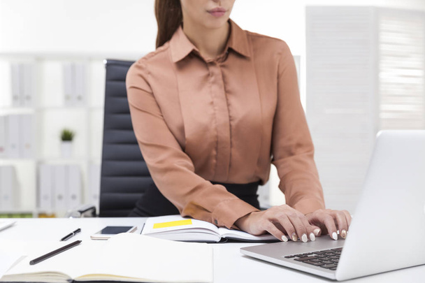 Woman in brown blouse typing - Zdjęcie, obraz