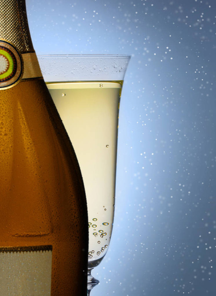 bottle of champagne with a glass closeup  - Fotó, kép