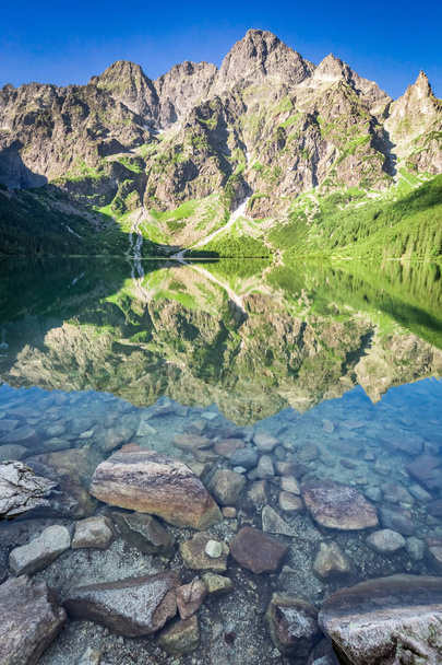 Stunning sunrise at lake in the Tatra Mountains in Poland - Photo, Image