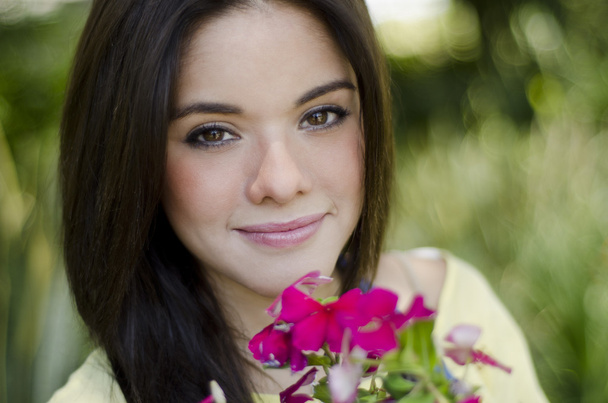 Portrait of a cute young woman in a garden - Photo, Image