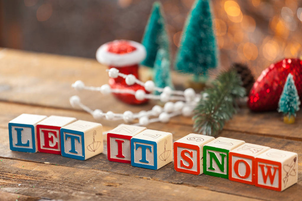 Let It Snow Written With Toy Blocks On Christmas Card Background - Foto, imagen