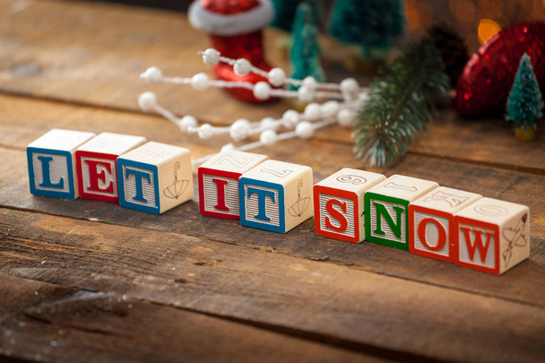 Let It Snow Written With Toy Blocks On Christmas Card Background - Foto, afbeelding