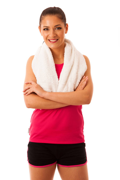 Woman rests after workout in fitness gym with towel around her n - Fotó, kép