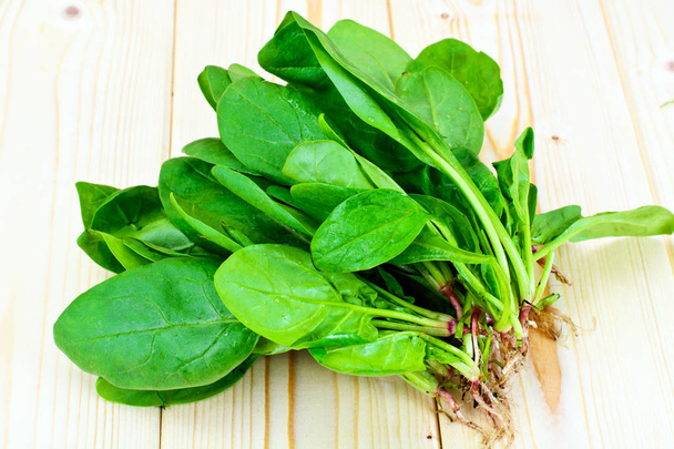 Juicy Fresh Spinach Leaves on Woody Background - Photo, Image