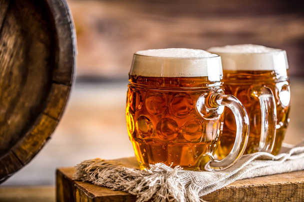 Beer. Two cold beers. Draft beer. Draft ale. Golden beer. Golden ale. Two gold beer with froth on top. Draft cold beer in glass jars in home pub hotel or restaurant. Empty beer glass. Still life - Foto, Imagen