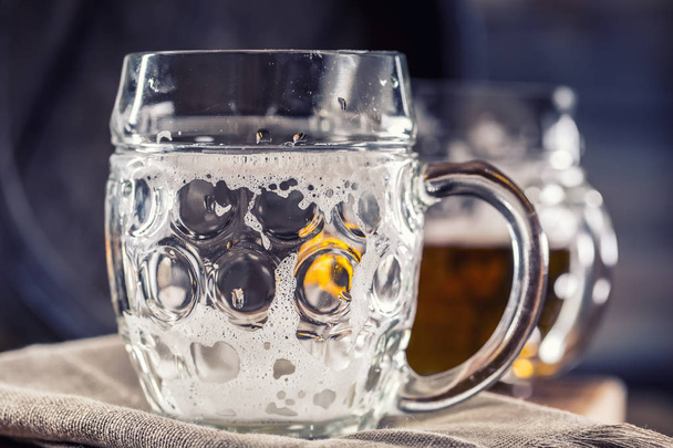 Beer. Two cold beers. Draft beer. Draft ale. Golden beer. Golden ale. Two gold beer with froth on top. Draft cold beer in glass jars in home pub hotel or restaurant. Empty beer glass. Still life - Fotoğraf, Görsel