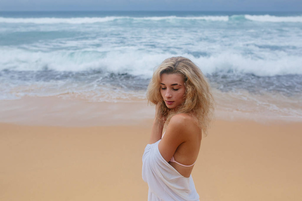 Beautiful young woman on beach - Photo, image