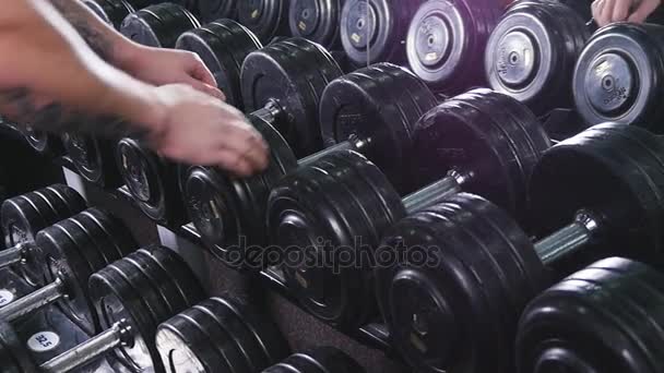 man takes with dumbbell stand - Footage, Video