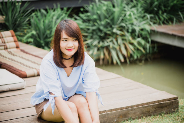 Woman smiling with perfect smile and white teeth in a park and looking at camera - Photo, Image
