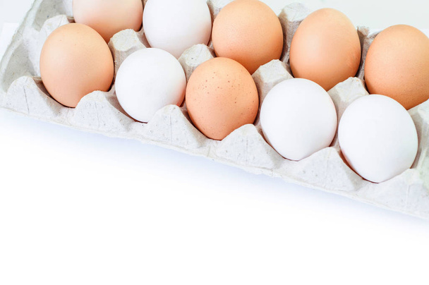 Different eggs in carton pack isolated on white - Φωτογραφία, εικόνα