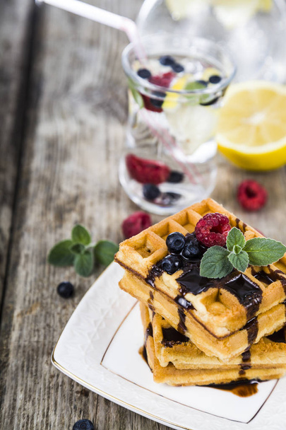 Belgian waffles with raspberries, blueberries and mint, covered  - Φωτογραφία, εικόνα