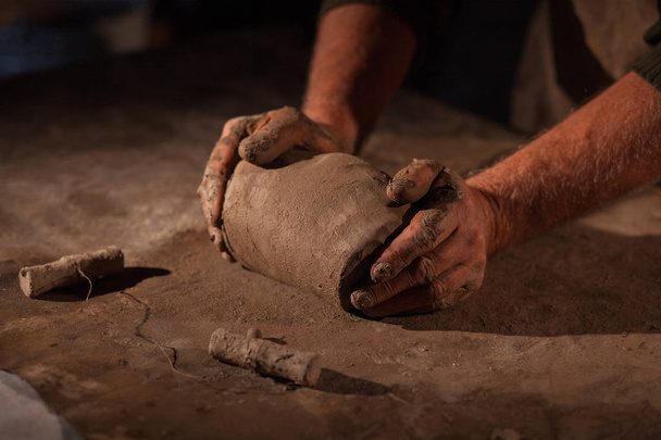 Hands of the potter knead clay. - Photo, Image