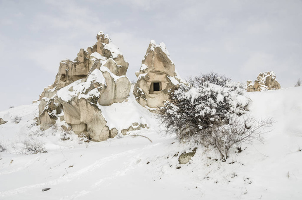 Unique geological rock formations under snow in Cappadocia, Turkey - Fotó, kép