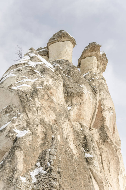 Unique geological rock formations under snow in Cappadocia, Turkey - Φωτογραφία, εικόνα
