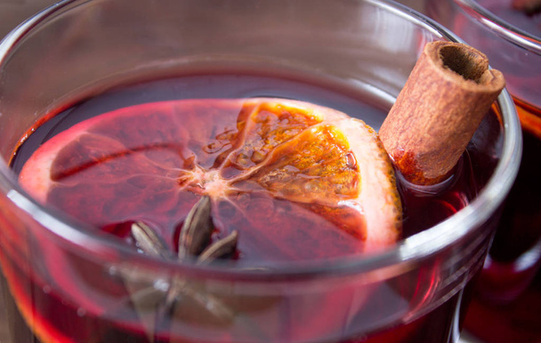 Mulled wine and spices on wooden background - Fotó, kép