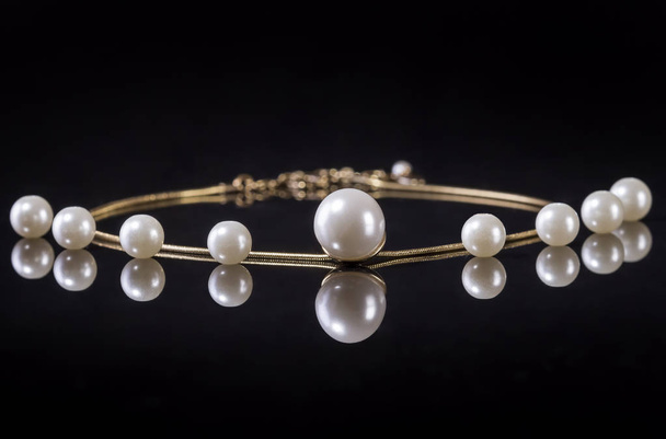White pearls necklace on black background - Photo, Image