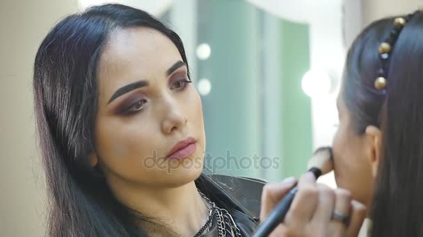 Glamour portrait of beautiful woman model with fresh daily makeup and romantic wavy hairstyle. Fashion shiny highlighter on skin, sexy gloss lips make-up and dark eyebrows - Video