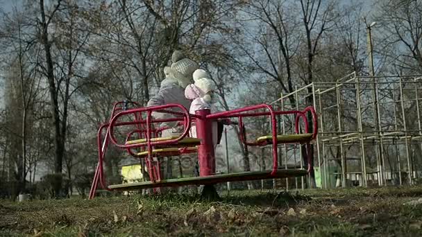 Mother with a Young Daughter Ride on a Swing in the Park - Footage, Video