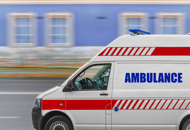 Ambulance service van driving fast on street - Foto, Imagen