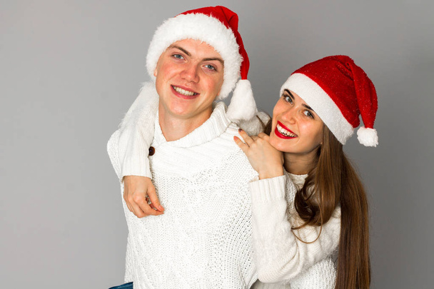 couple in love celebrates christmas in santa hat - Фото, зображення