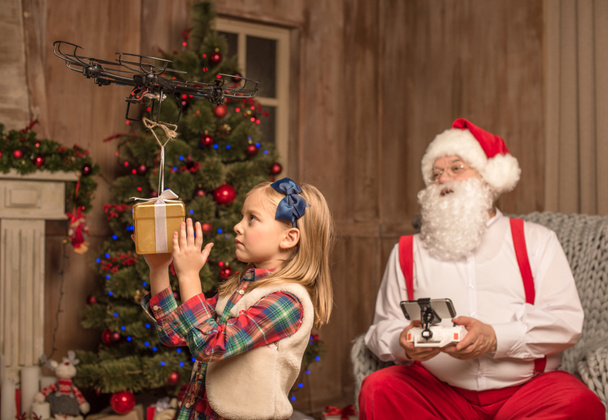 Santa with kid using hexacopter drone - Photo, Image