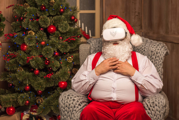 Santa Claus wearing virtual reality headset  - Фото, зображення