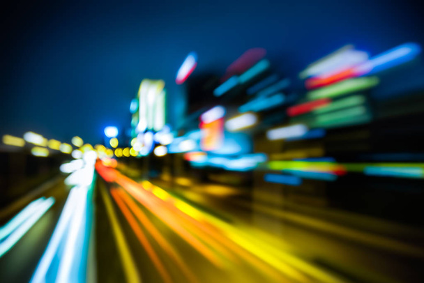 blurred traffic light trails on road at night in China. - Fotoğraf, Görsel