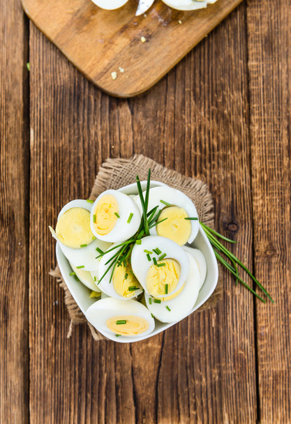 Wooden table with halved Eggs  - Photo, Image