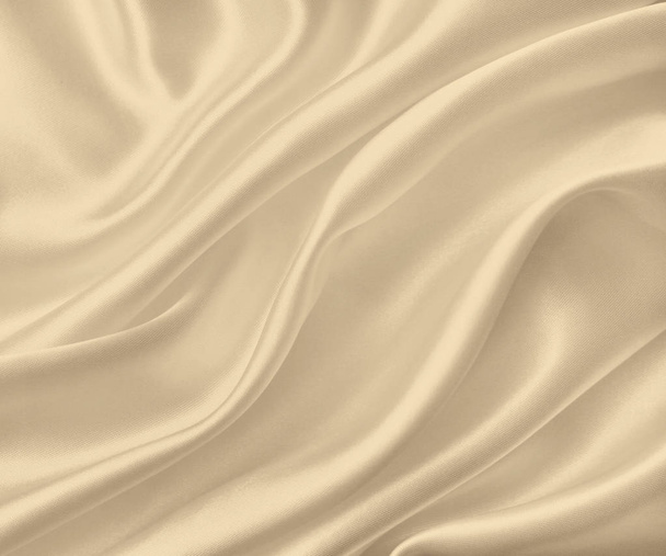 Smooth elegant golden silk or satin texture as background. In Se - Фото, изображение