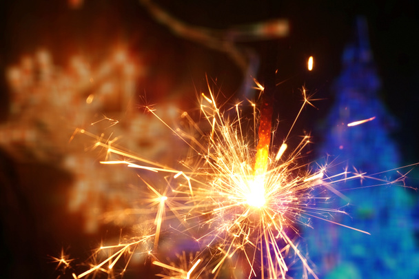 Sparkler and colorful bokeh christmas new year background - Photo, Image