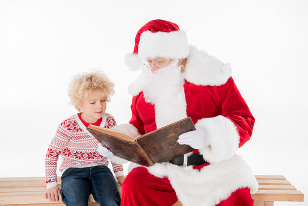 Santa Claus reading book with kid  - Fotoğraf, Görsel