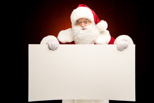Père Noël montrant modèle de Noël
  - Photo, image