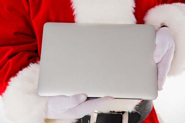 Santa Claus hand showing laptop - Фото, изображение