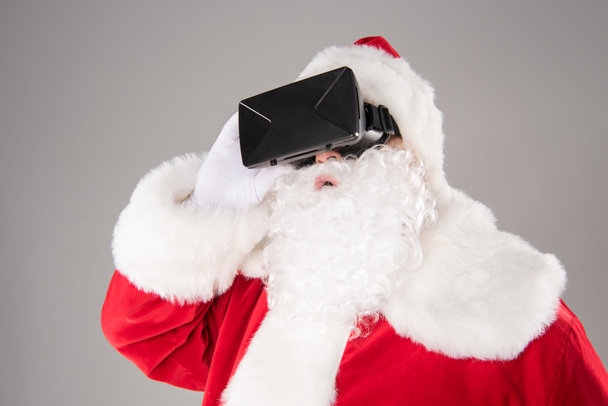 Άγιος Βασίλης φοράει σετ κεφαλής εικονικής πραγματικότητας   - Φωτογραφία, εικόνα