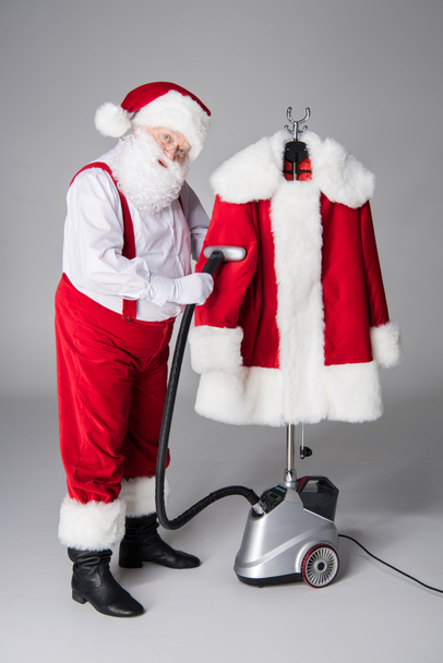 Santa Claus schoonmaak jas - Foto, afbeelding