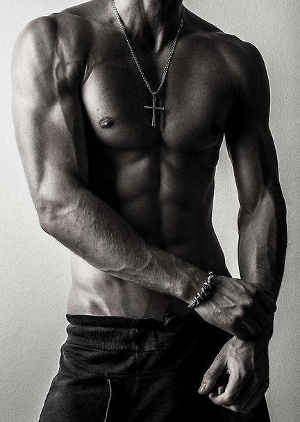 Beautiful and health athletic caucasian muscular young man. Black-white photo. - 写真・画像