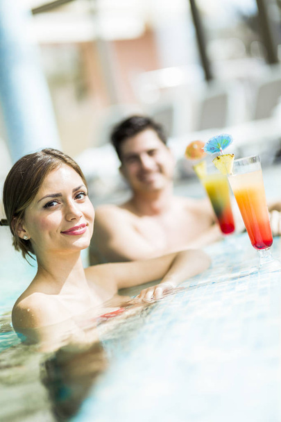Young people drinking cocktails by the swimming pool   - Photo, Image