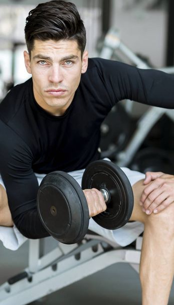 Young man training in a gym - Photo, Image