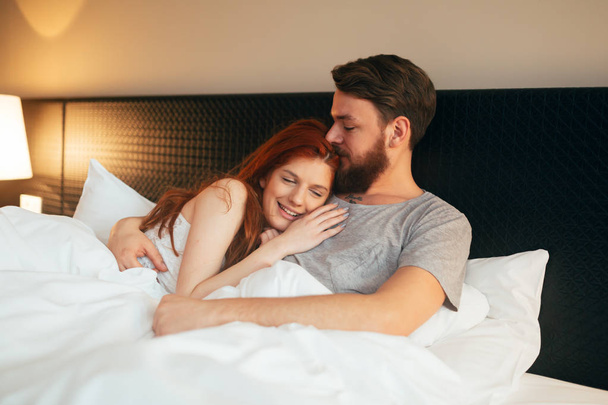 Sensual couple in bed being romantic - Foto, imagen