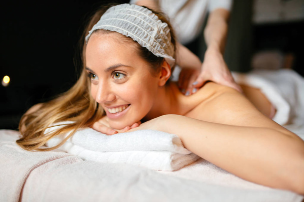 Massage therapist massaging woman - Fotoğraf, Görsel