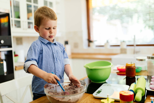 Adorable child making cookies - Photo, Image