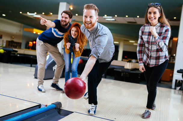 Friends having fun while bowling - Fotó, kép