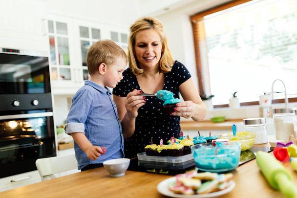 Mother and child preparing muffins - 写真・画像