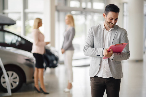 Salesperson selling cars at dealership - Photo, image