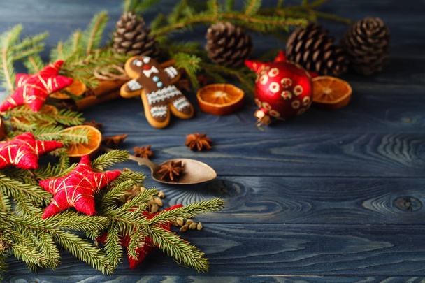 Christmas gingerbread cookies against background branch of fir t - Fotoğraf, Görsel
