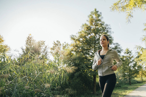 Fit female jogger running  - Valokuva, kuva